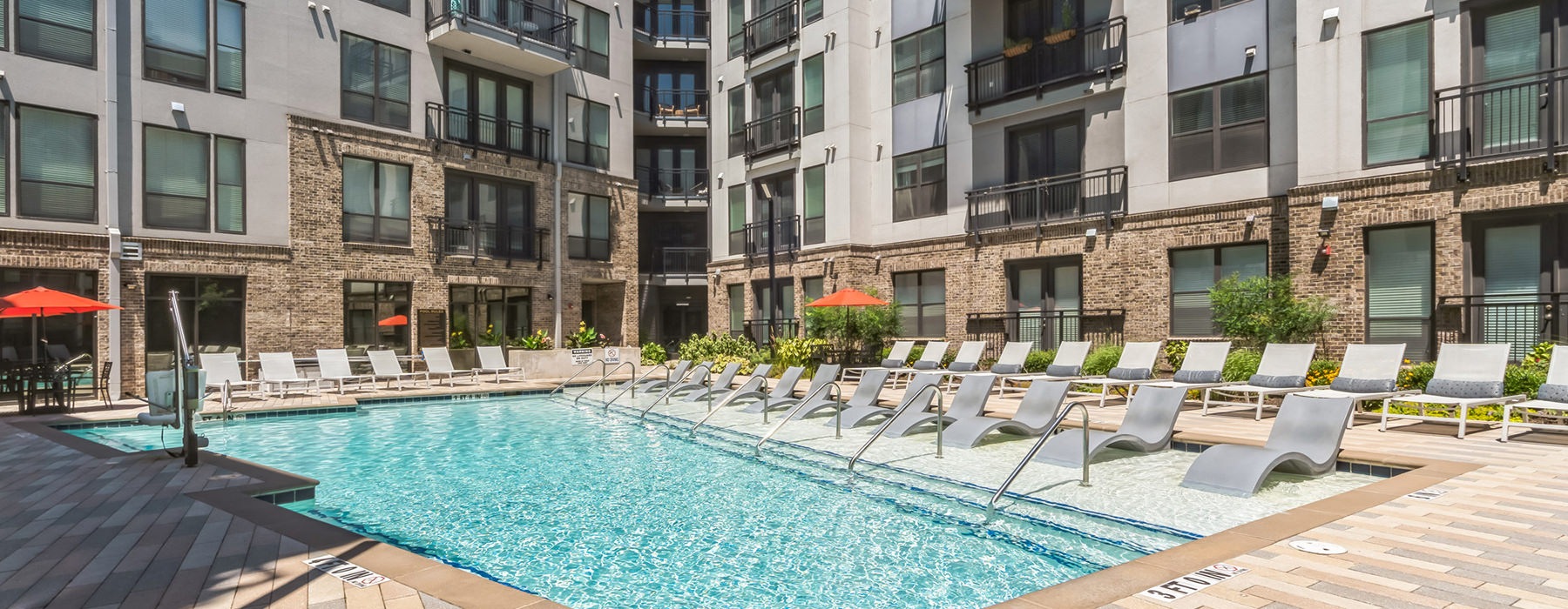 a swimming pool in a courtyard between buildings