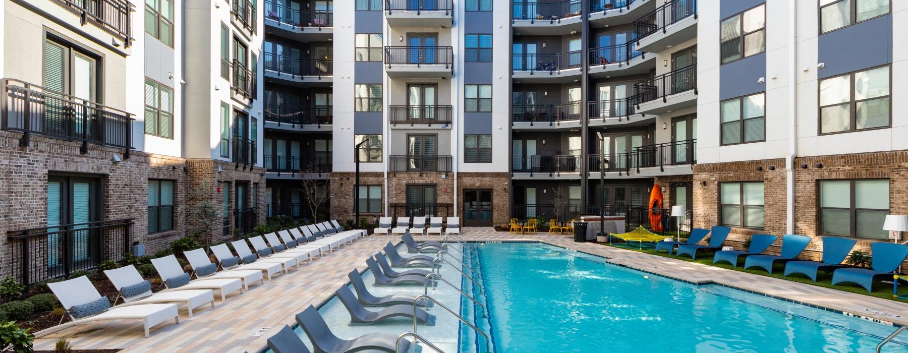 a swimming pool in a courtyard between buildings